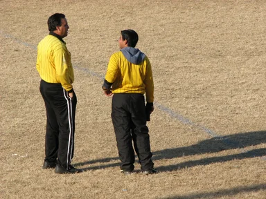 Free Stock Photo: Two soccer referees talking