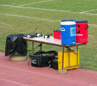 Free Stock Photo: Water coolers and headsets on a sports field sideline