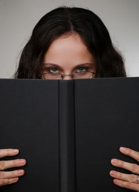 Free Stock Photo: A beautiful business woman looking over a book