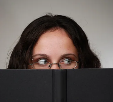 Free Stock Photo: A beautiful business woman looking over a book