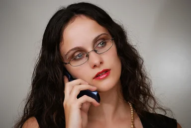 Free Stock Photo: A beautiful business woman talking on a cell phone