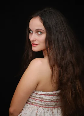 Free Stock Photo: A beautiful young woman posing before a black background