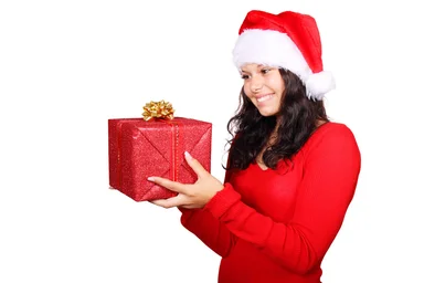 Free Stock Photo: A beautiful young woman with a Christmas present