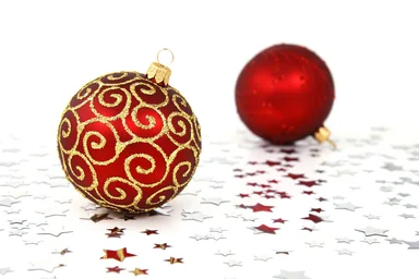 Free Stock Photo: Two red Christmas ornaments on a white floor