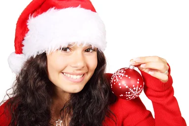 Free Stock Photo: A beautiful young woman with a Christmas hat and an ornament