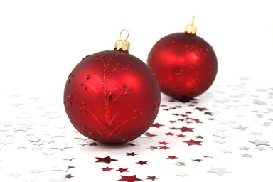 Free Stock Photo: Two red Christmas ornaments with silver stars on the floor