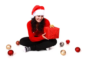 Free Stock Photo: A beautiful young woman with a Christmas gift on a white background