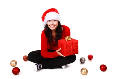 Free Stock Photo: A beautiful young woman with a Christmas gift on a white background