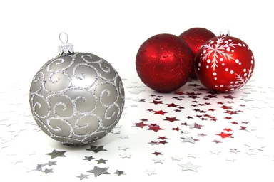 Free Stock Photo: Red and silver Christmas ornaments with silver stars on a white floor