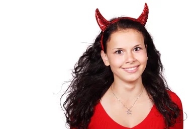Free Stock Photo: A beautiful girl in a red devil costume isolated on a white background