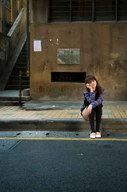 Free Stock Photo: A beautiful Chinese girl sitting on a curb