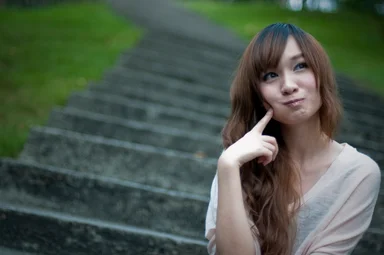Free Stock Photo: A beautiful Chinese girl sitting on steps making a silly face