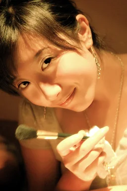 Free Stock Photo: A beautiful Chinese girl holding a make-up brush