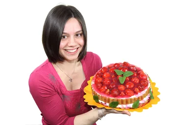 Free Stock Photo: A beautiful woman holding a strawberry cake isolated on a white background