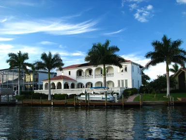 Free Stock Photo: A fancy house along the water with palm trees