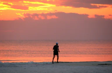 Free Stock Photo: A person running on the beach during sunset