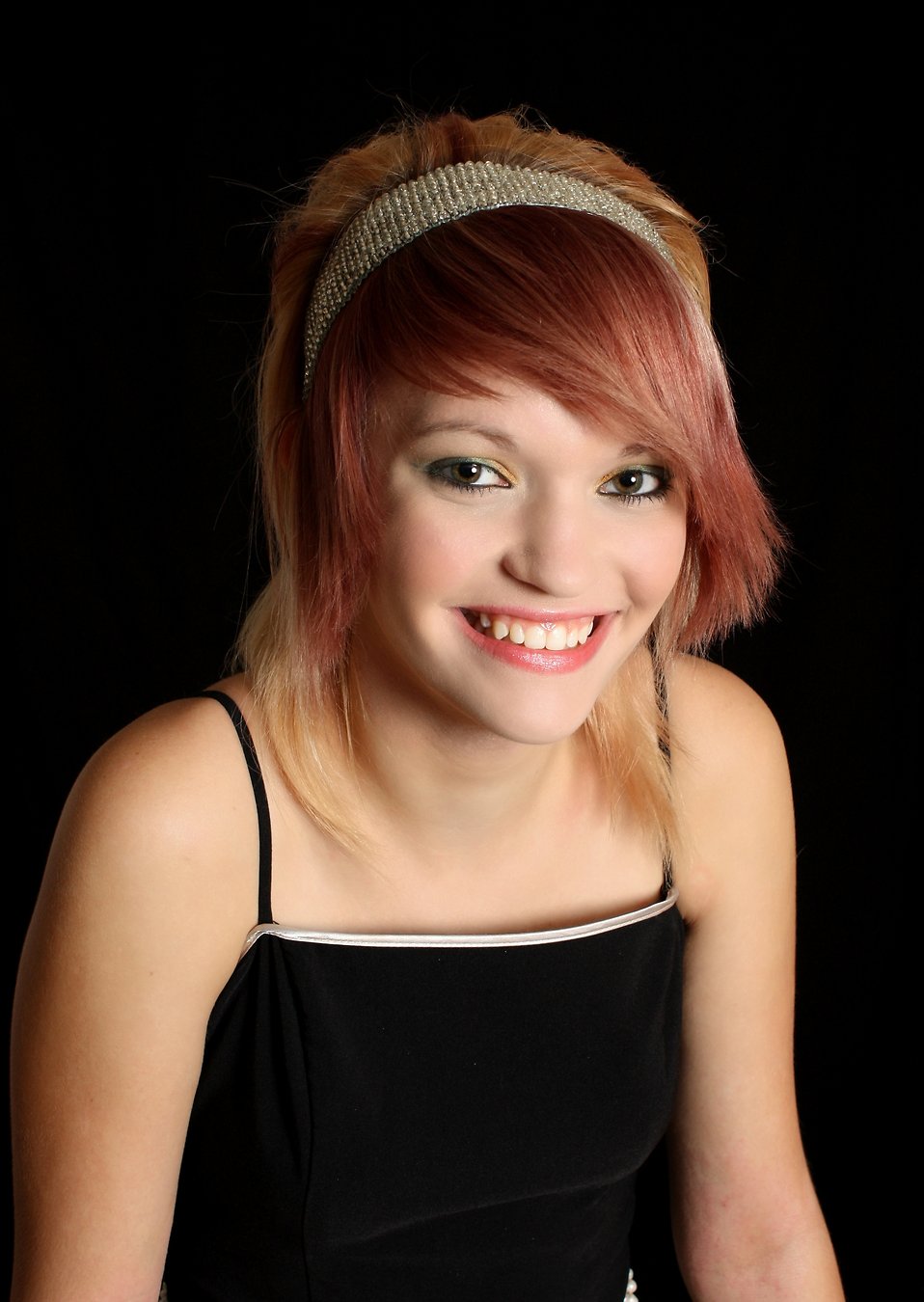 A beautiful young woman posing with a black background : Free Stock Photo